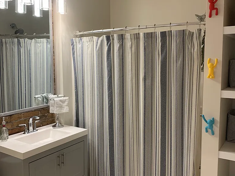 modern luxury bathroom with ample storage and bath tub & shower