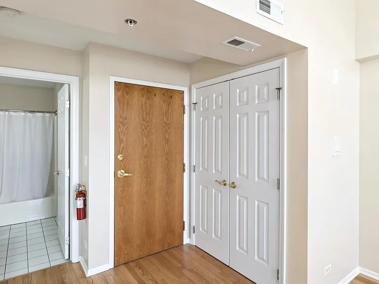 Entrance to the Residence. Double Doors to the right for Washer-Dryer Center. Door to the Left is Entry to Bathroom.