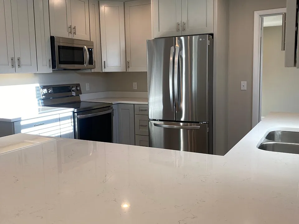 All new quartz countertops - shiplap peninsula, new stainless steel appliances, shaker slow close cabinets, recessed lighting, very nice!