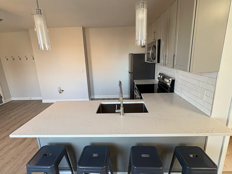 Entertain friends around your large peninsula island. Four bar stools are included.