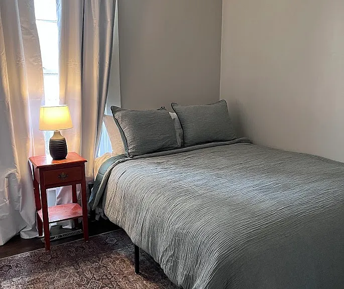 Downstairs bedroom with a queen size bed and a walk in closet