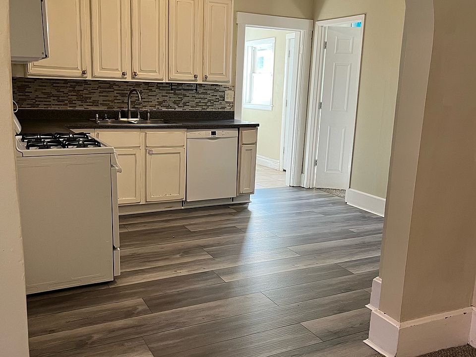 Cozy white kitchen with beautiful new gray flooring