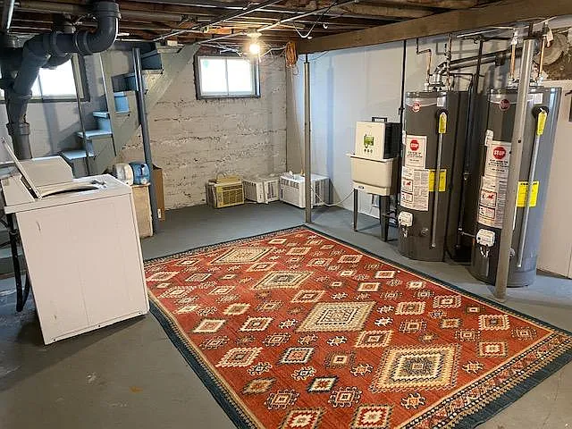 Shared laundry room area - coin operated machines and newer water heaters