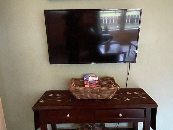 The smart TV with remote in the drawer below.