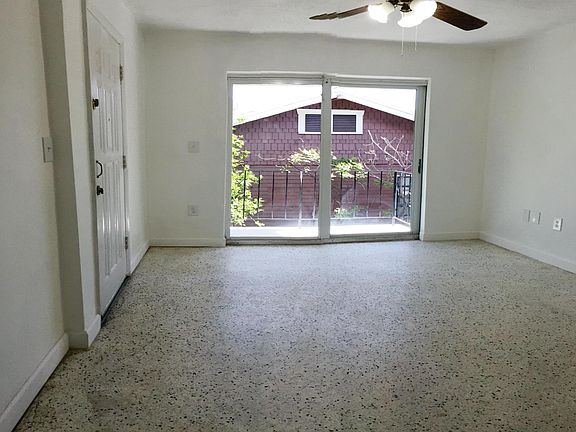 Spacious living area with ceiling fan