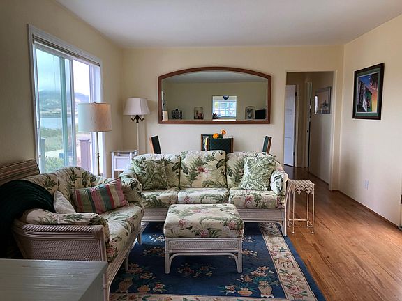 Living room area with small dining table behind the couch.