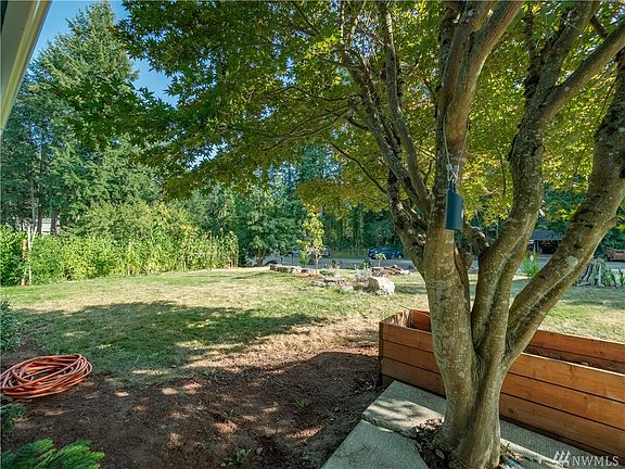 Beautifully landscaped yard with a variety of fruit trees: Apple, Peach, Pear, Plum, Fig, Persimmons. You'll also enjoy the seasonal Grapes, Blue Berries, Boysenberries, Rasberries and Marion Berries.