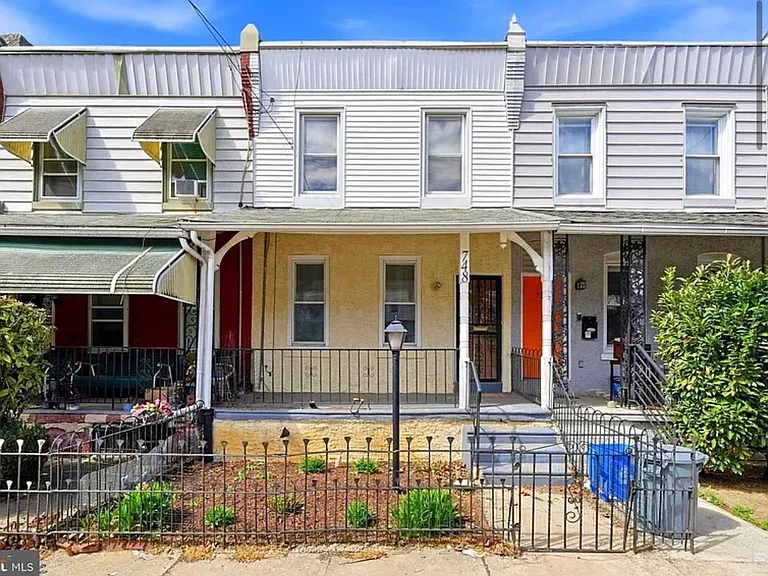 Yellow rowhome with front porch & garden