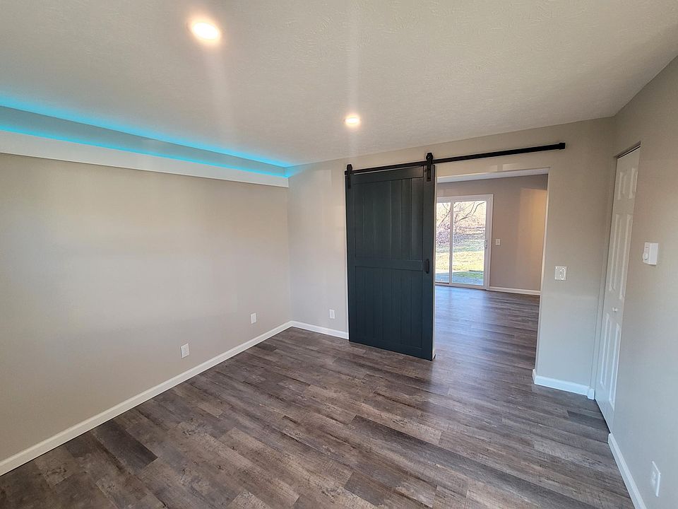 FAMILY ROOM - ACCENT LIGHTING, LED CAN LIGHTING, BARN DOOR, LUXURY VINYL PLANK FLOORING, NEUTRAL COLORS
