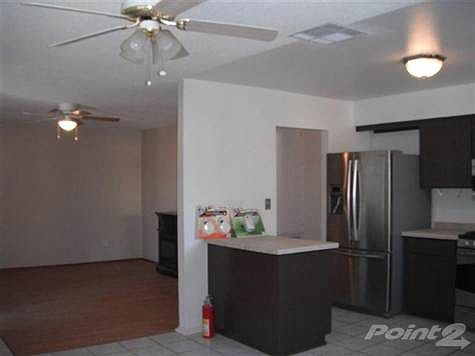 laminated floors at living room and ceiling fan light fixtures.