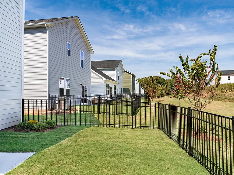 Outdoor space at Amavi Brier Creek, where fenced yards and open views complement private living in a well-connected Durham community.