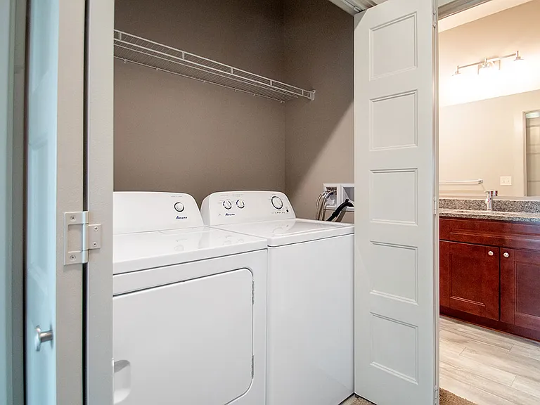 In-unit washer and dryer next to bathroom at Avenue 204.