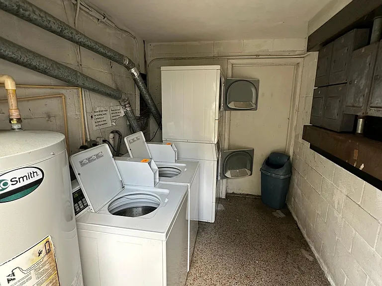 Shared laundry next door (the black door in center of building). Coin- operated by quarters