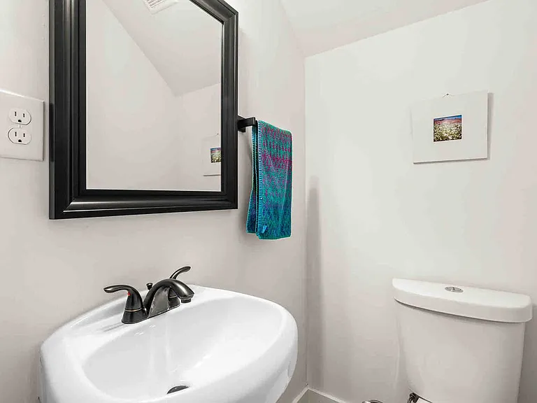 Downstairs half bathroom next to stairs