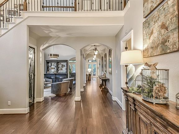 Beautiful two story foyer with wine room to the left and arched doorways leading to the gracious living areas.