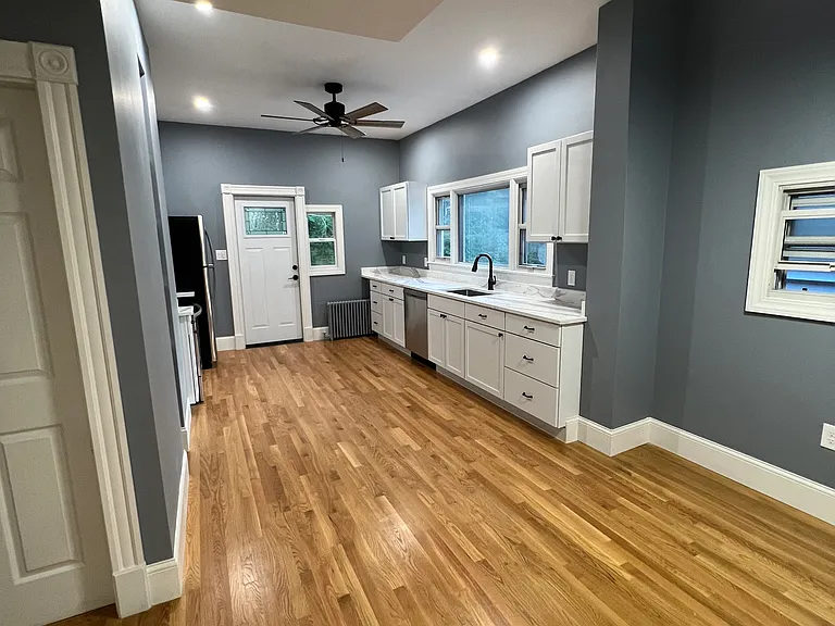Eat-in kitchen with granite countertops and stainless steel appliances.