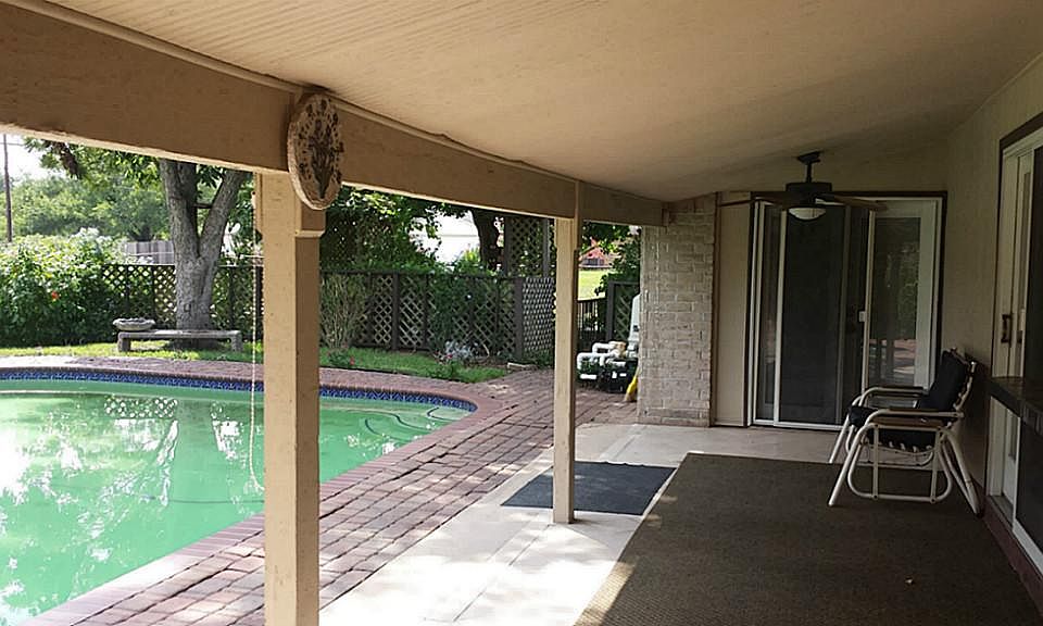 Large covered patio area with pass through window to kitchen for entertaining.