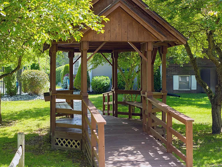 Relax in the shade under our charming gazebo, your perfect spot for outdoor tranquility.