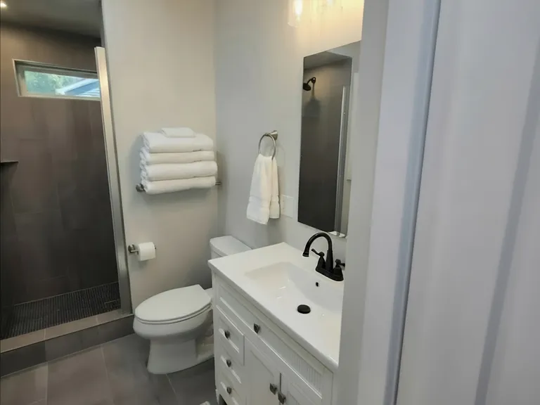 Bathroom #1 attached to Bedroom #1. All new bathroom, including tile, fixtures, vanity, walk in shower. Light and bright.