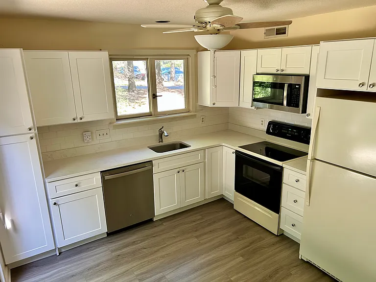 Sunny Kitchen with new cabinets and access to Patio.