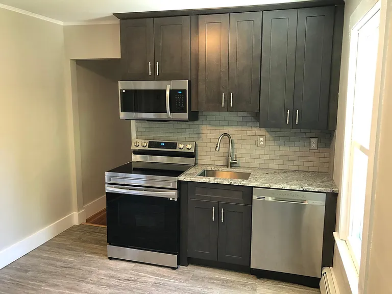 New cabinets, granite counters, tile backsplash and stainless steel appliances