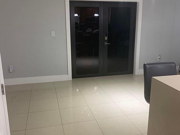 Dinning Area and Kitchen Counter area with access to the back terrace and modern fan.