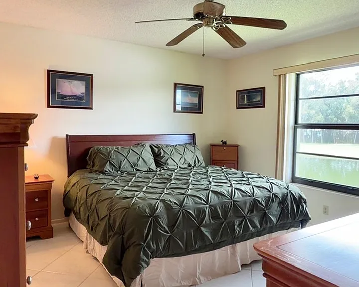 Entering Primary bedroom w/ stunning lake & golf course views!