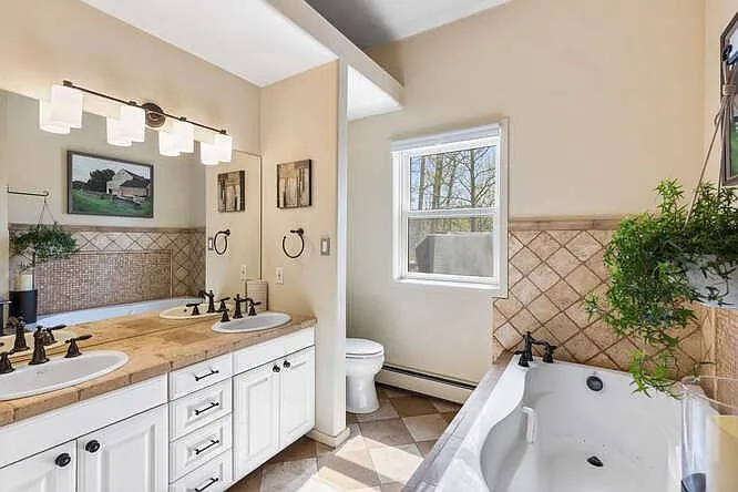 Ensuite bathroom on main level, with tub and separate walk-in shower