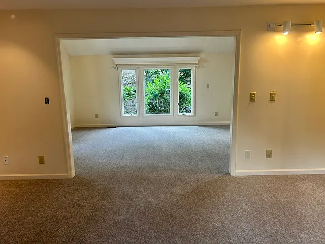 Front room picture taken from the family room and exhibiting the open concept of the home