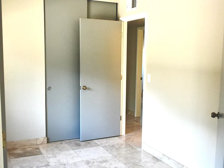 3rd Bedroom/Den/Office/Game Room has a door to the Hallway and a closet with built-in shelves and rods