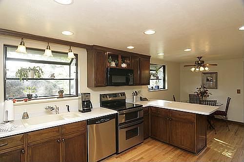 The eat-in kitchen includes stainless steel appliances and hardwood floors.