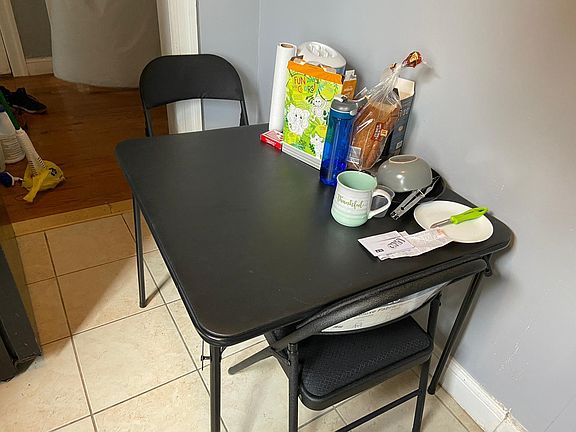 Kitchen can fit a table with four chairs, fridge included in the unit. There's another space could fit a cabinet nearby the bathroom.