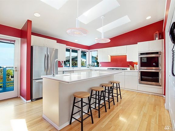 Beautiful kitchen with an island and bar seating. Corian counter tops. Stainless steel appliances.