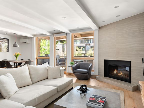 Living Room has Fireplace and Balcony with Aspen Mountain View