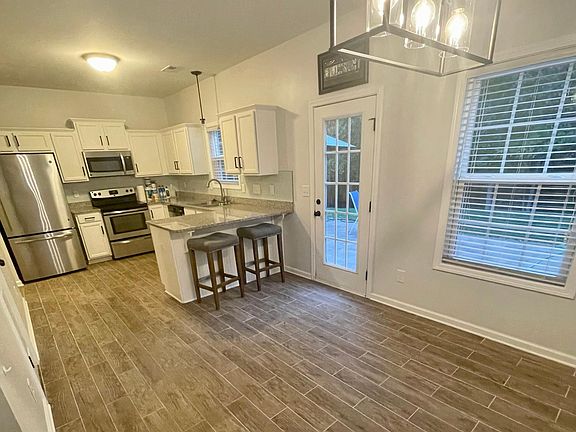 Open Kitchen Dining Area with door to Backyard Patio