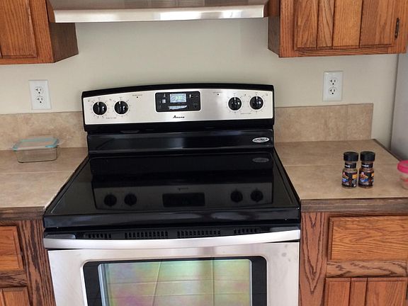 Stainless steel range with flat top.