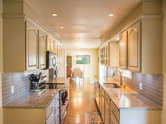 Updated kitchen with granite counters. Looking toward dining room.