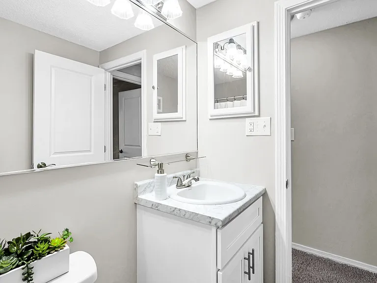 Our bathrooms are elegantly remodeled, featuring expansive mirrors and exuberant vanity lighting that exude timeless elegance.