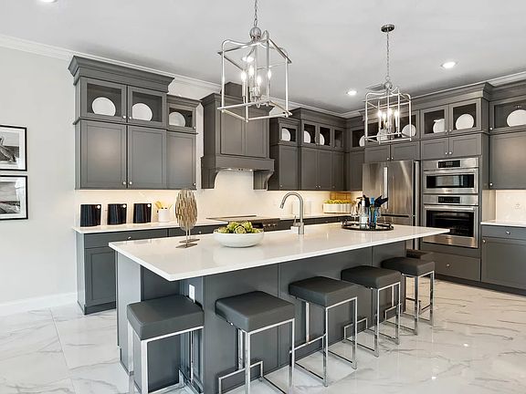 Kitchen with pendant lighting and glass upper cabinets
