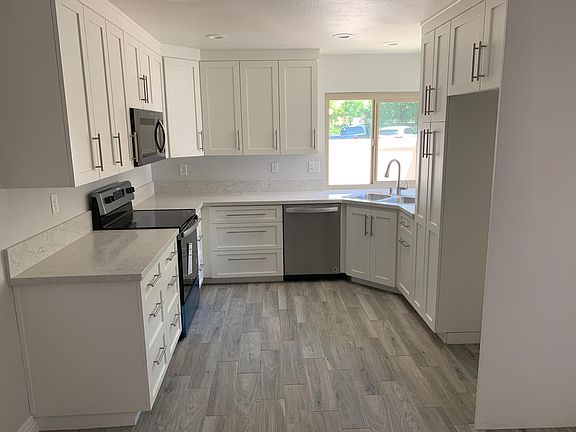 Newly renovated Kitchen, Quartz counter top, porcelain plank tile floor and double pane windows.