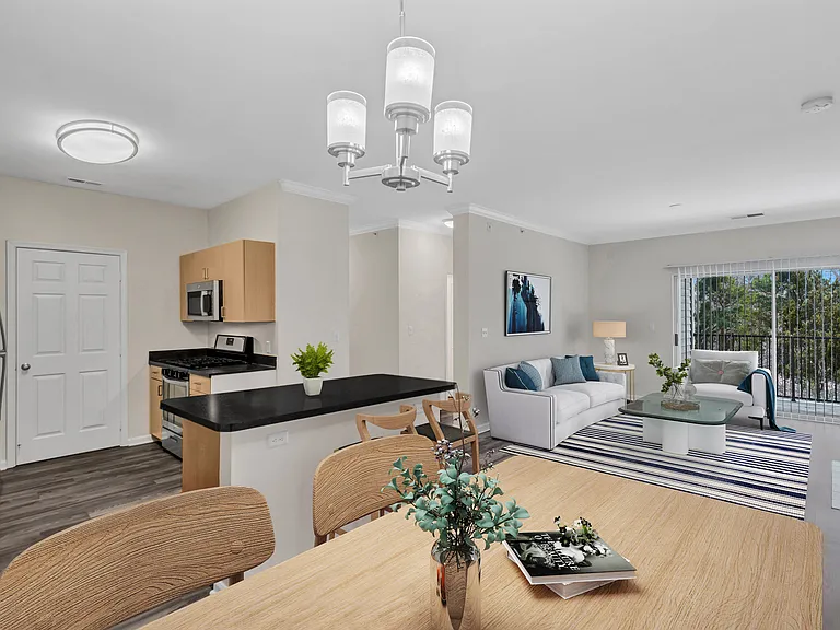 A modern kitchen with a dining table set for four.