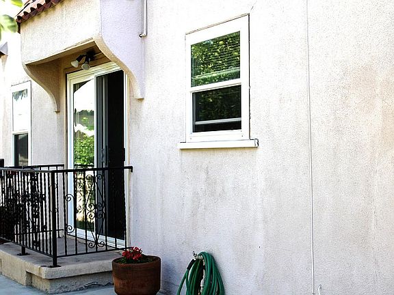 Outside balcony overlooks the yard from the living room.