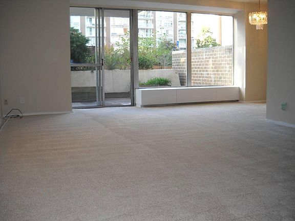 Older photo showing the apartment empty. Planter was updated so outside patio looks different.