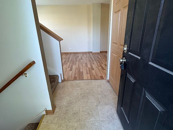 Front door Entry. Foyer has stairs going up and down to the left and a powder room to the right.