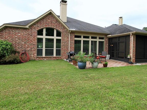 Many windows enjoy the scenic views while you also have a patio and screened-in back porch to enjoy this relaxing back yard.