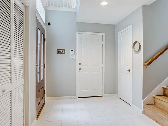 Super clean, bright and light. Entry with garage access, coat closet, downstairs bath and bedroom/office/flex room. Access to the patio area and utility. Front foyer flooring has been updated since the owner purchased. User friendly and easy maintena