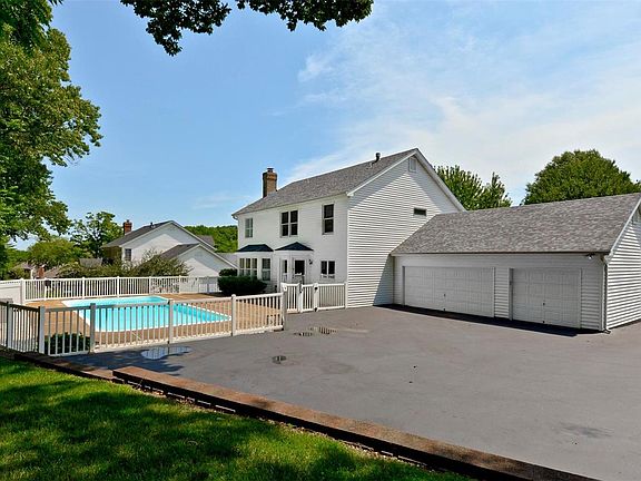 Back view, 3 car garage, plenty of parking, flat backyard area and pool