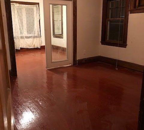Formal dining room leading through french doors to living ro