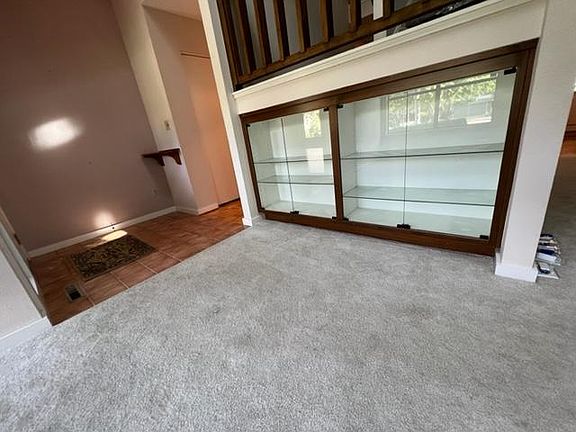 Looking back toward entry from living room-Lighted display case