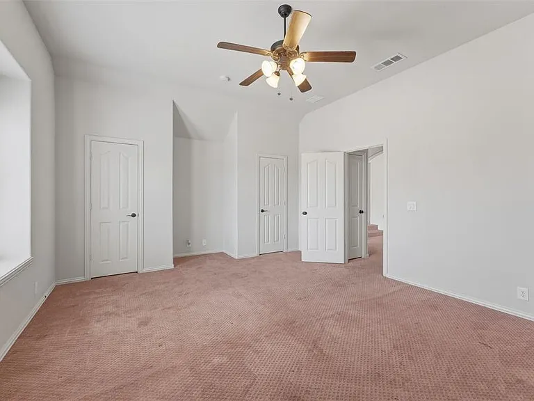 5th bedroom with light colored carpet and ceiling fan
